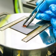 Fabricated component being loaded for flip-chip bonding.