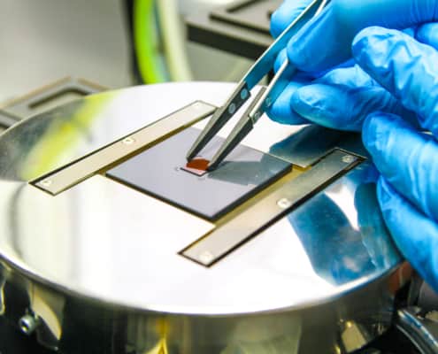 Fabricated component being loaded for flip-chip bonding.