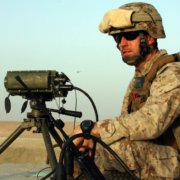 Solider employs a GLTD-II laser target designator during a Tactical Air Control Party training shoot
