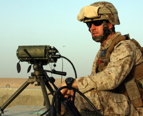 Solider employs a GLTD-II laser target designator during a Tactical Air Control Party training shoot