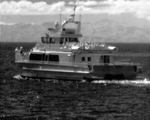 Attollo Engineering Phoenix SWIR Camera Core with 5 micron pixel pitch and low SWaP (Size, Weight and Power). Image of Boat in Open Water with Channel Island in Background.
