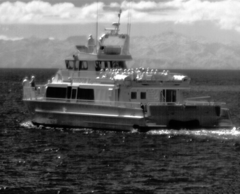 Attollo Engineering Phoenix SWIR Camera Core with 5 micron pixel pitch and low SWaP (Size, Weight and Power). Image of Boat in Open Water with Channel Island in Background.